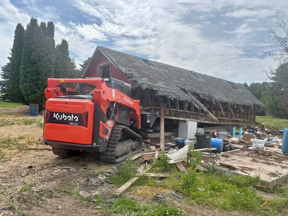 Demolition equipment beside a partially removed structure
